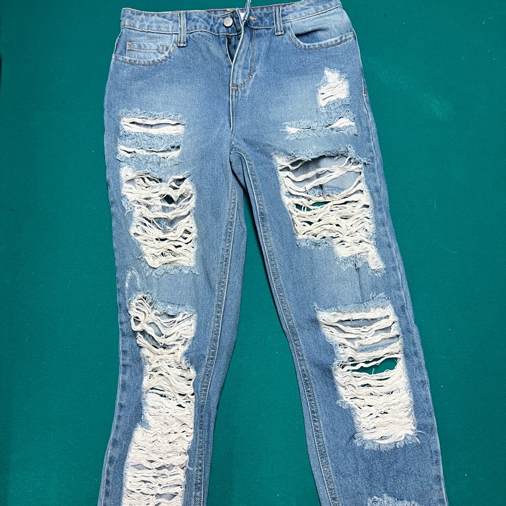 Distressed ripped blue denim jeans